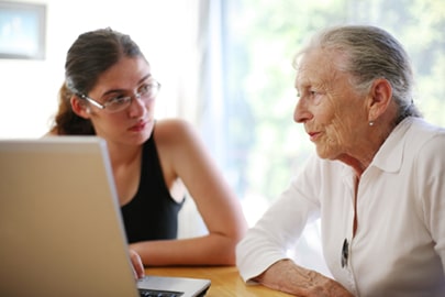 Grandmother and granddaughter. Grandmother and granddaughter with laptop.